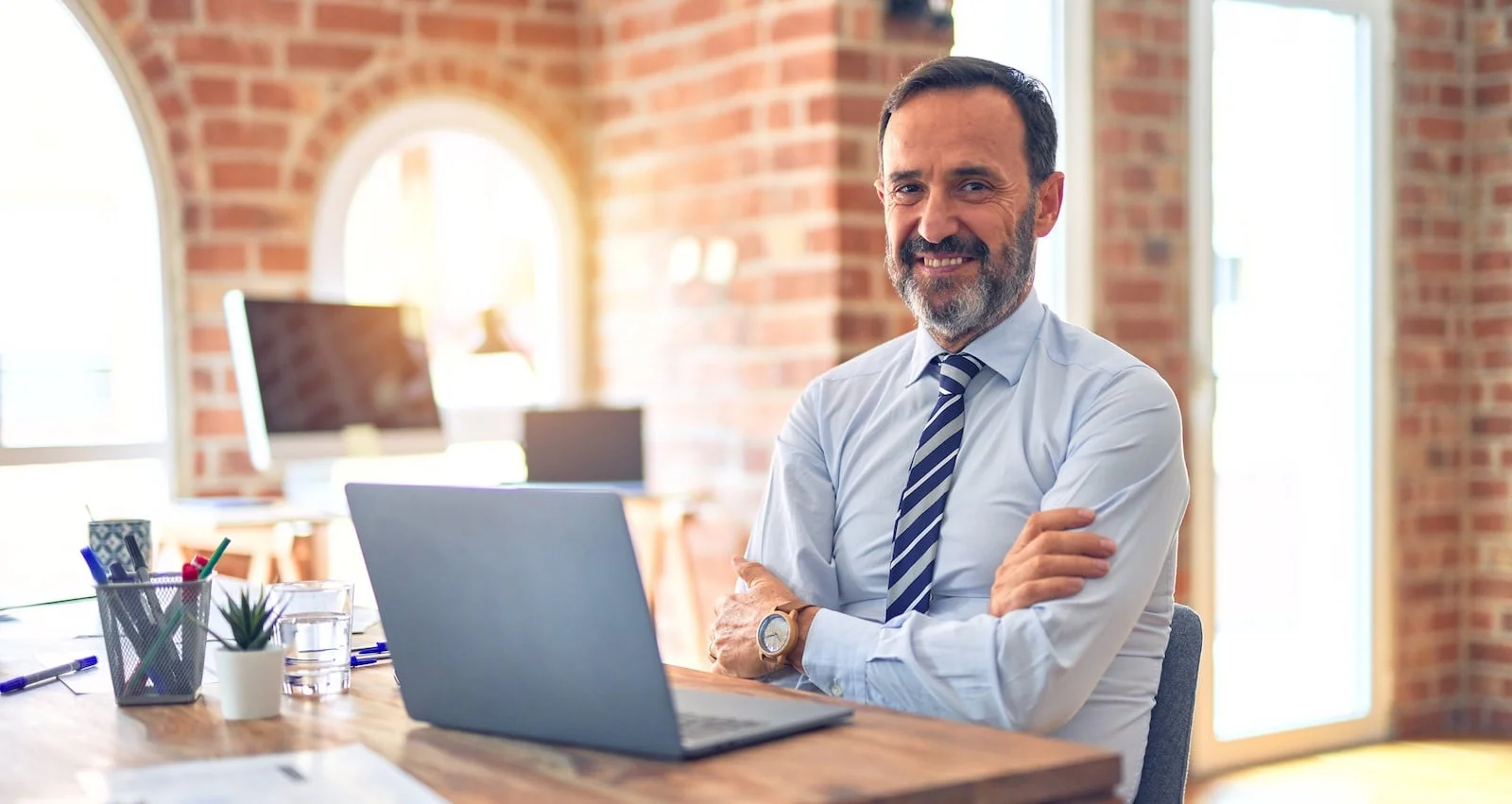 business man at desk smiling